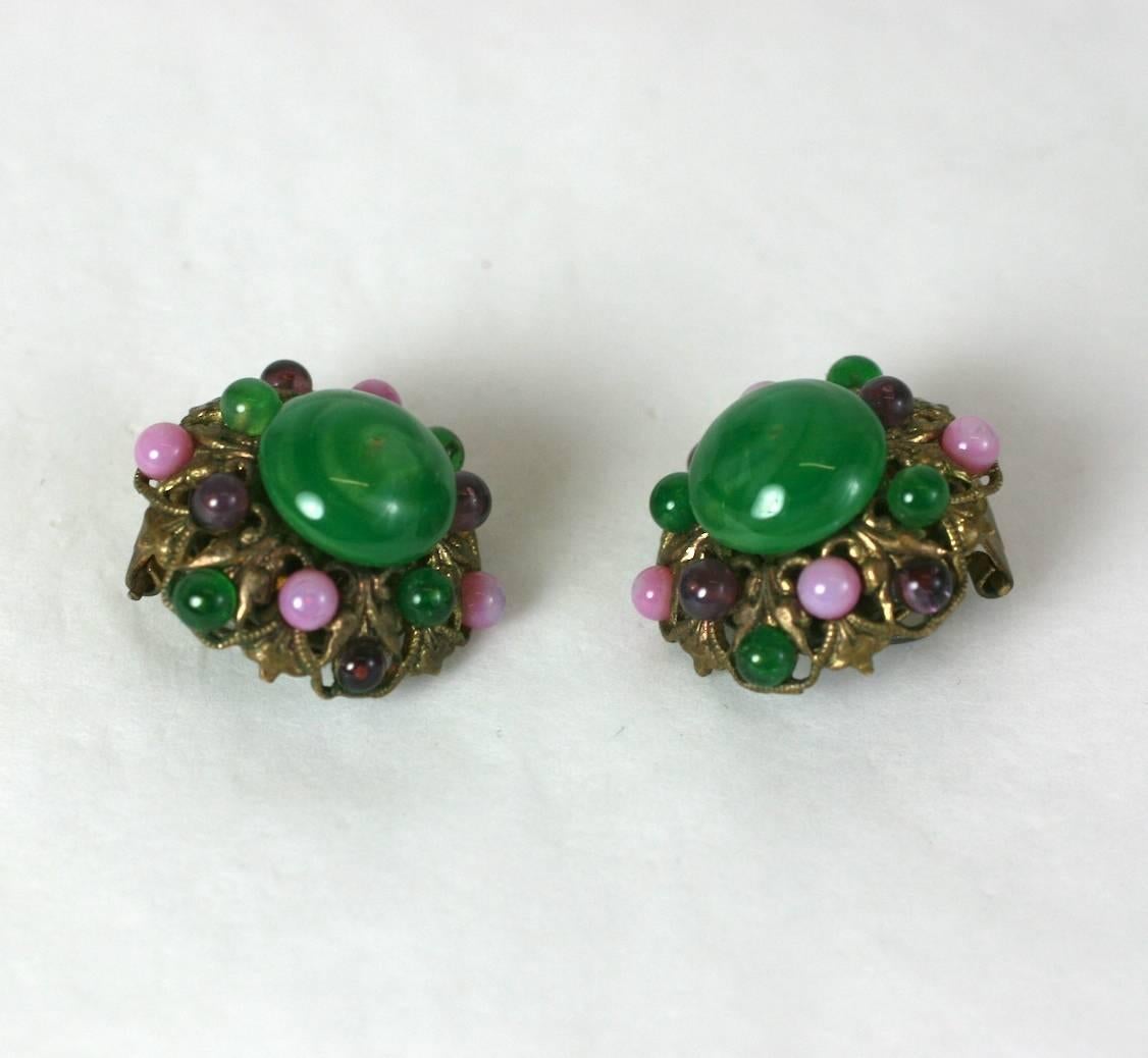 Louis Rousselet pate de verre earclips. The gilt hexagonal ear clips further decorated with faux jade, amythest and rose quartz hand formed pate de verre cabochons in baroque filigree settings. Clip back fittings. 1930's France. 
Excellent