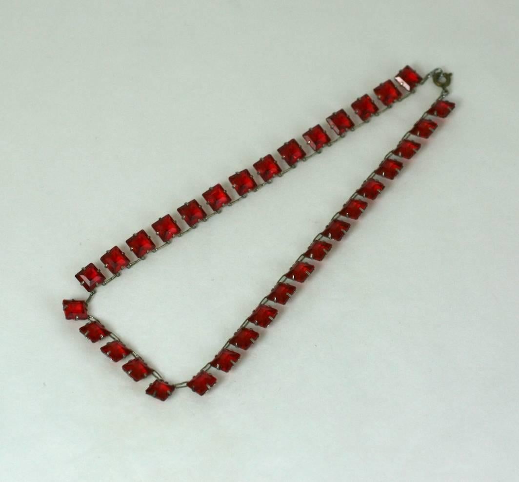 Unusual Art Deco faux ruby crystal riviere. The deep ruby faceted square cut crystals are set in open back silver gilt linked settings. Excellent Condition. 1920's France. 
Length 15.25 "
Width 5/16" 