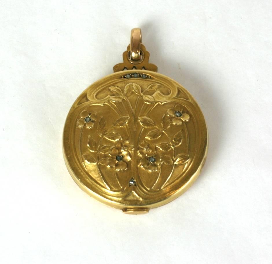 French Art Nouveau Mirror Locket set in 18k gold with tiny rose diamonds. Lovely locket with picture frame (under glass) opposite mirror on interior. 
Locket slides to open and has wonderful floral decorations with rose diamond accents on front. An