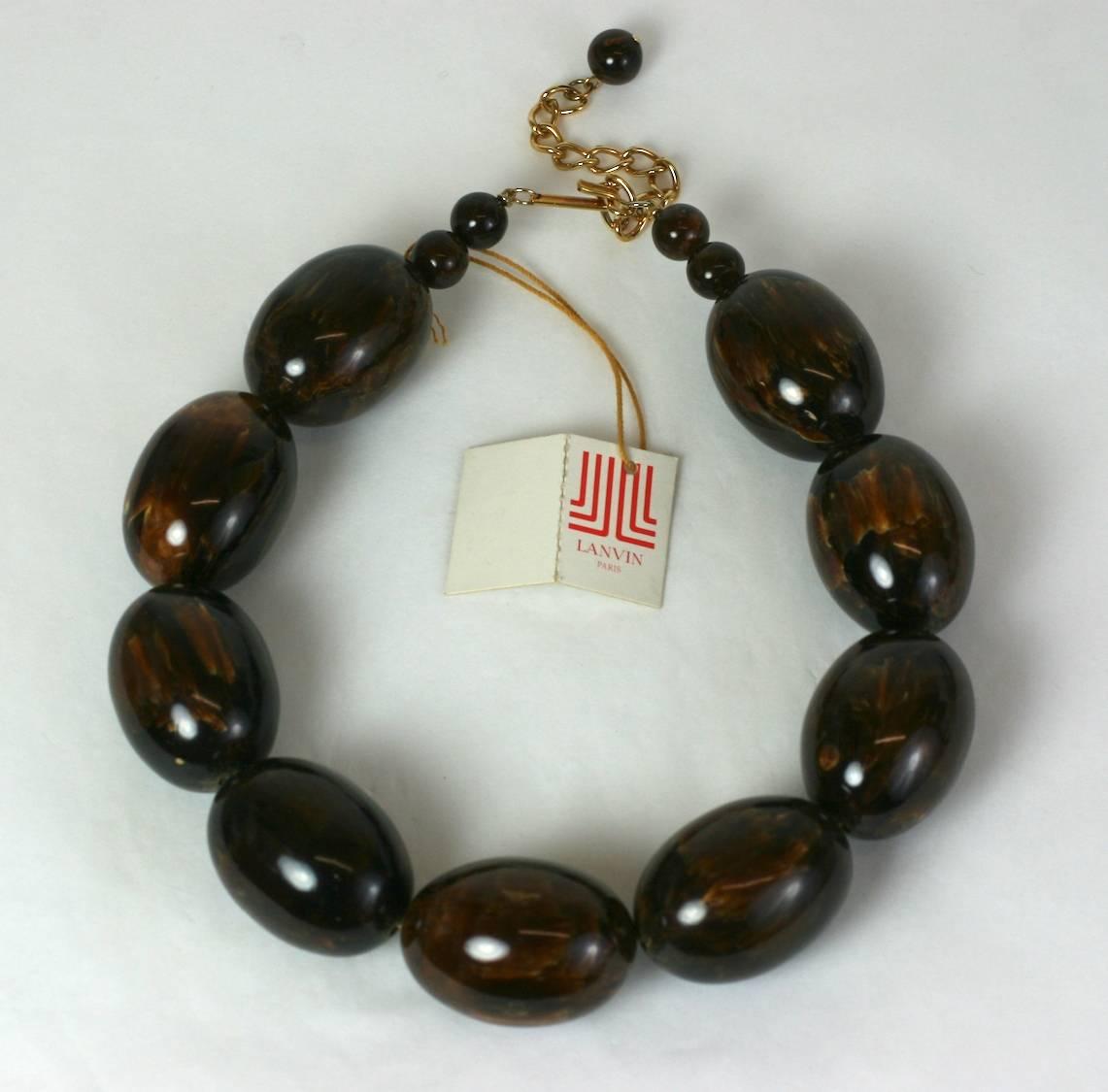 Lanvin End of Day Brown Bakelite Beads from the 1970's. Oversized mottled brown bakelite egg shaped beads are used for this imposing necklace. 
Retains original paper label. 1970's France.
Excellent condition. 
Adjusts from 16" to 19", 