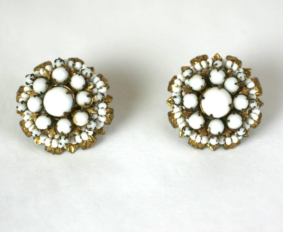 Miriam Haskell hand sewn white flower head button earrings. Made from signature Russian gilt filigrees and white pate de verre beads. Clip back fittings. 
Excellent Condition. 1950's USA. 
Diameter 1"