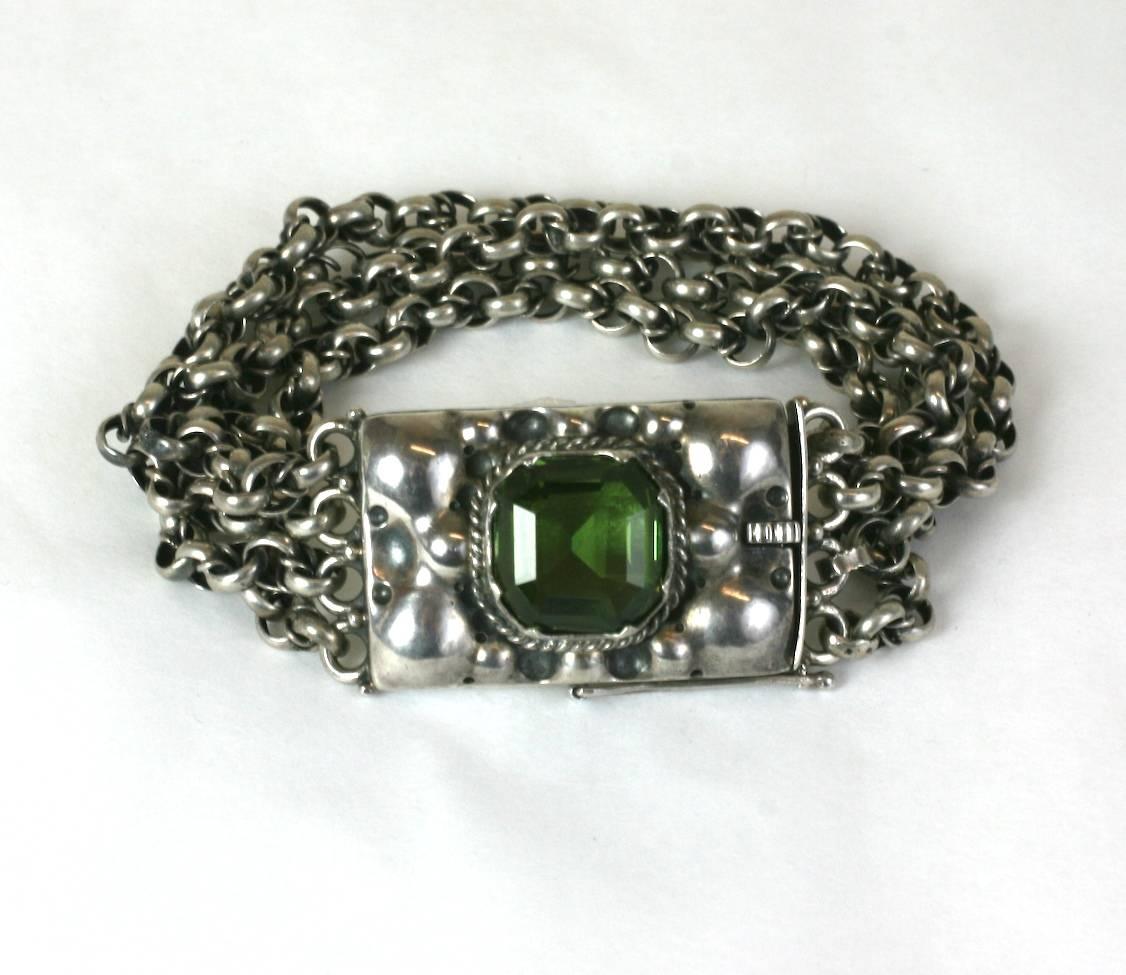 European Arts and Crafts Bracelet in 800 standard silver from the 1930's. Hand repousse with large faux green tourmaline and hand made link chain.  7.5
