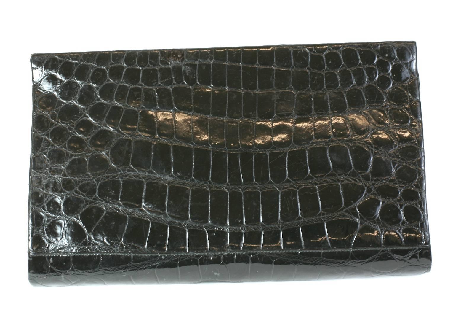 Manon Black Alligator Clutch with retractable silver chain handles. Simple elegant shape with central compartment and 2 side compartments for small items (chains are held here). Small marcasite stones trim the corners. 1960's USA.  Chains