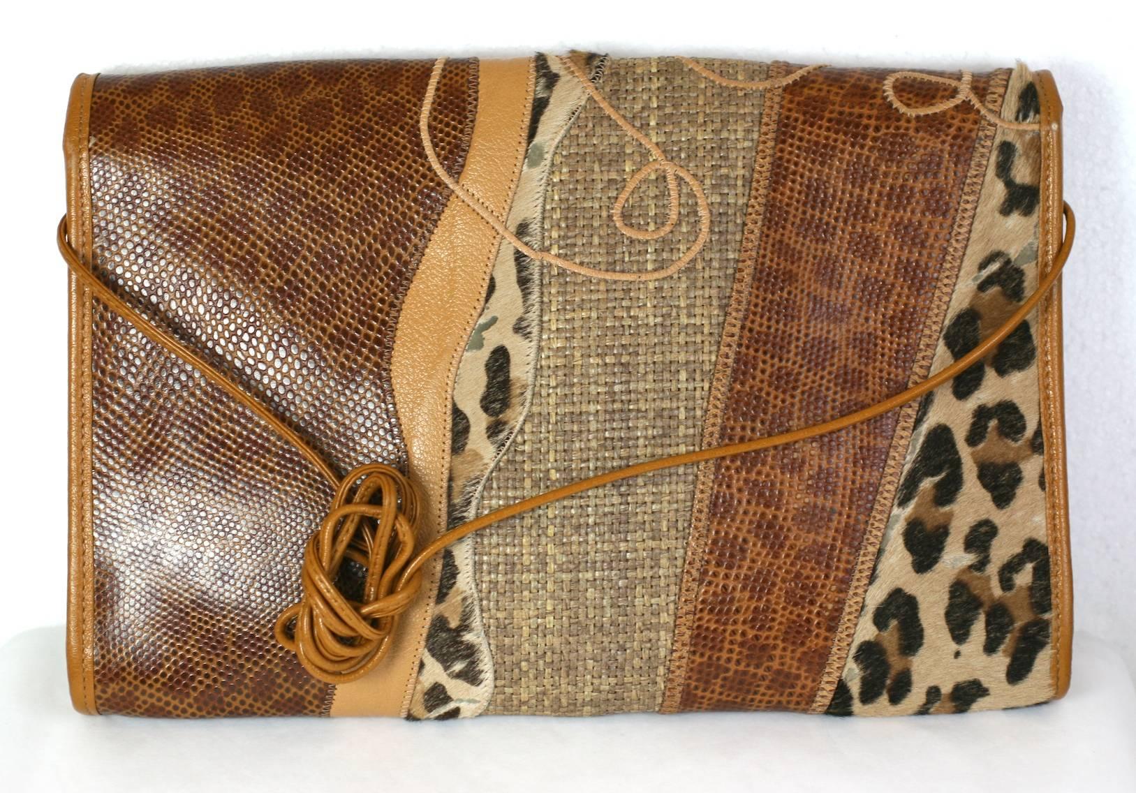 Carlos Falchi Pieced Clutch of snake, leather and faux pony skin printed leopard.
12