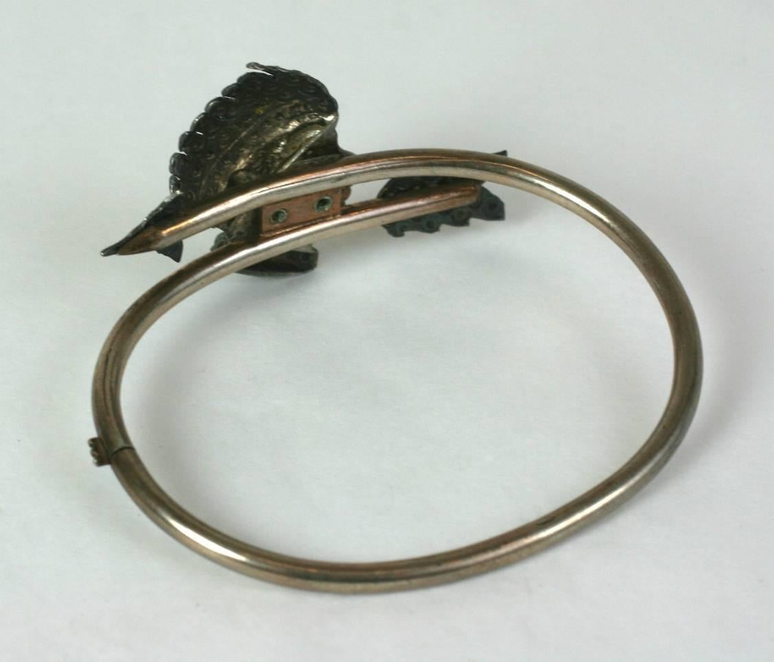 Unusual Victorian Bangle, possibly with a Native American profile depected from the mid to late 19th Century. The profile and arrow motifs are textured to simulate rose cut diamond set stones on a hard bangle which twists to open and close. 
Unusual