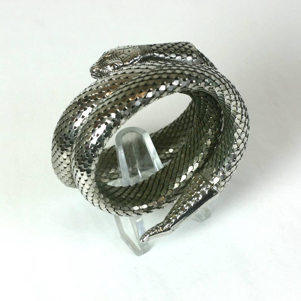 Whiting and Davis Coiled Snake Bracelet of chromed metal with highly detailed finishes. Each scale is articulated in the metal mesh which ends in finely detailed head and tail end caps. Coiled to wrap around wrist or upper arm. 1960's USA.  Width