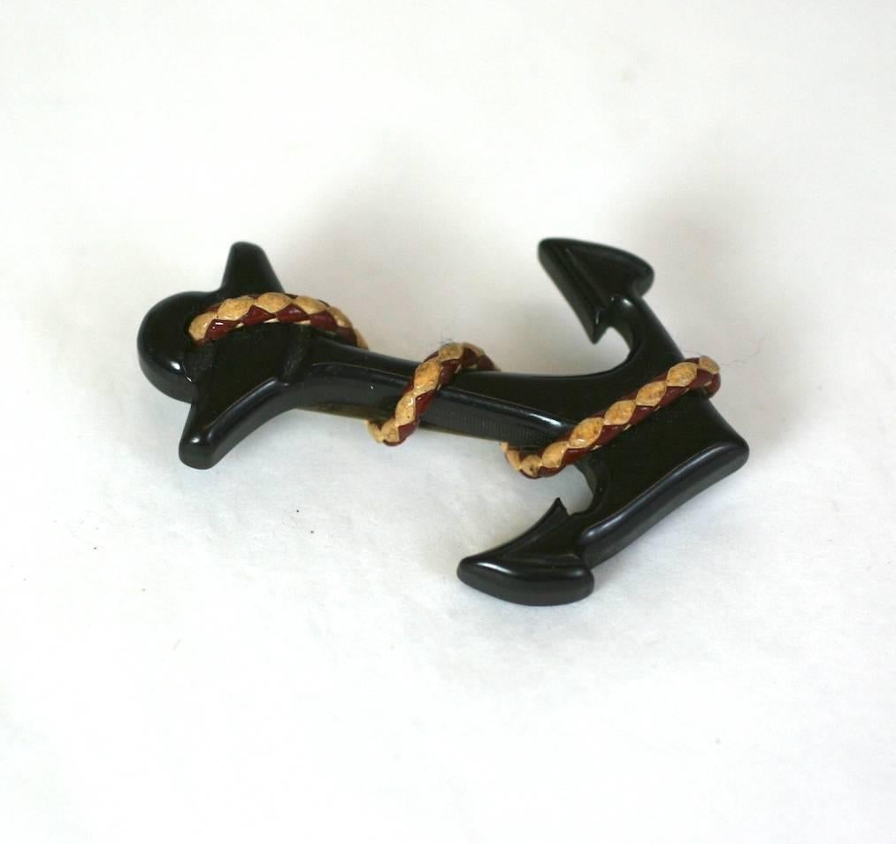 Bakelite Anchor Brooch of hand carved black bakelite with braided red and white lariat cord detailing. 
1930's USA. Excellent Condition.
Length  2.50