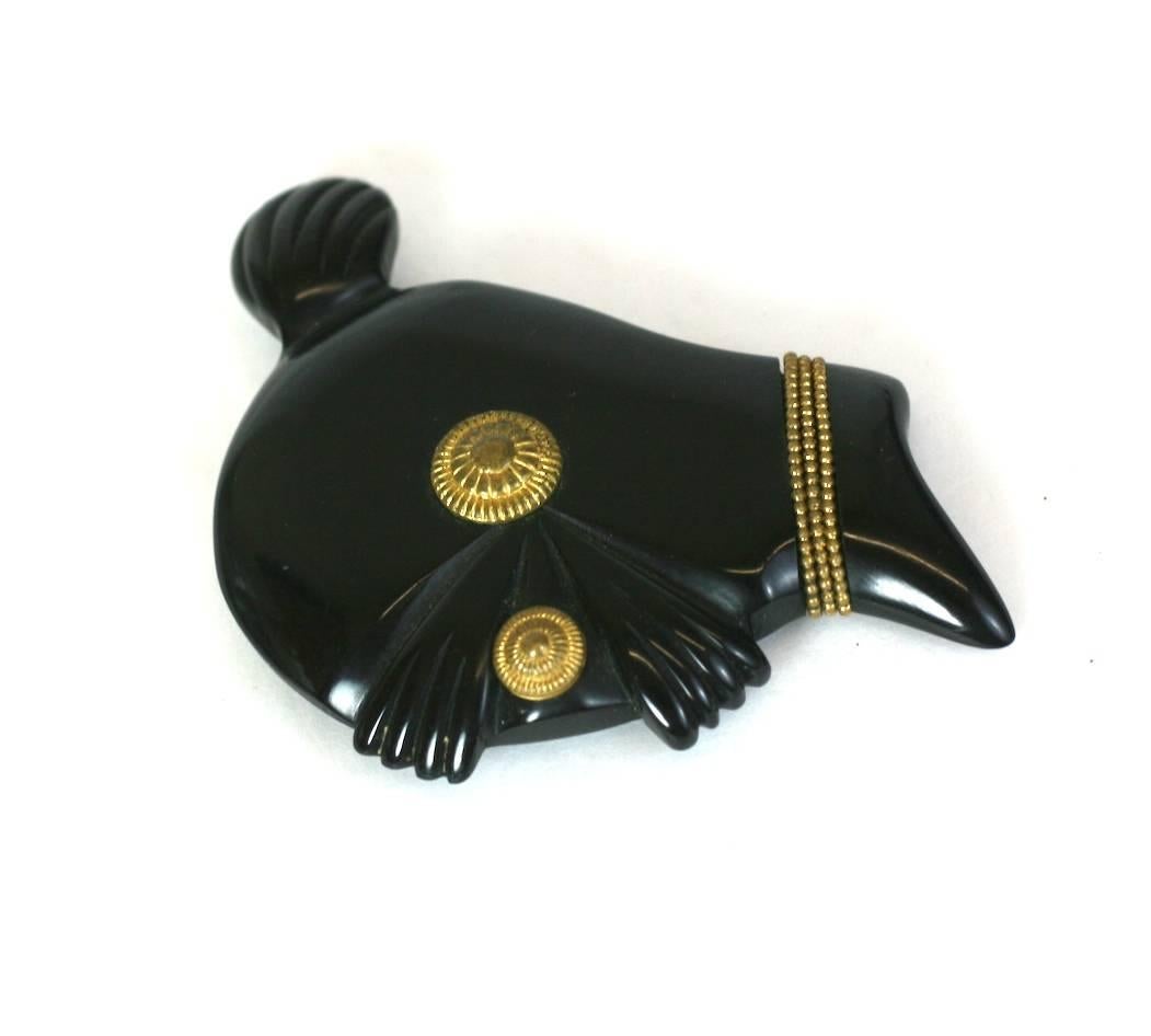 Unusual Art Deco Bakelite Knight Clip from the 1930's. Hand carved and decorated with gilt wires and gilded discs. Strangely cool subject matter. Brooch can clip onto edge of a lapel, neckline or pocket. 1930's USA. 
Excellent condition. 
2.25