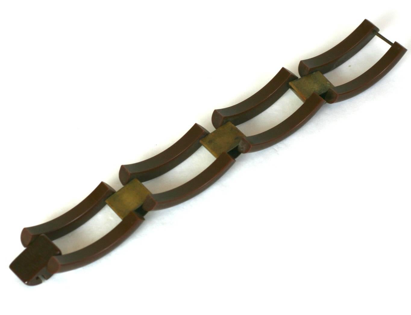 Brown Bakelite Deco Tank Bracelet with brass spacers. Bakelite self clasp. 
 1930's USA. 7" x 1".
Excellent condition. 