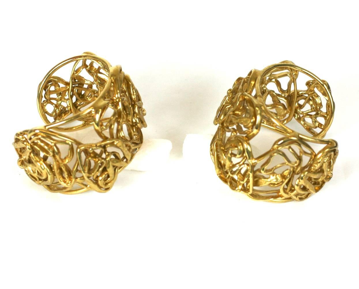 Amazing Yves Saint Laurent sculptural gilt hand made cuffs by Maison Goosens. Artisanally crafted of gilded hammered wire coiled into layers of abstract hearts, which was one of YSL signature motifs. Signed YSL, Made in France. Excellent Condition.