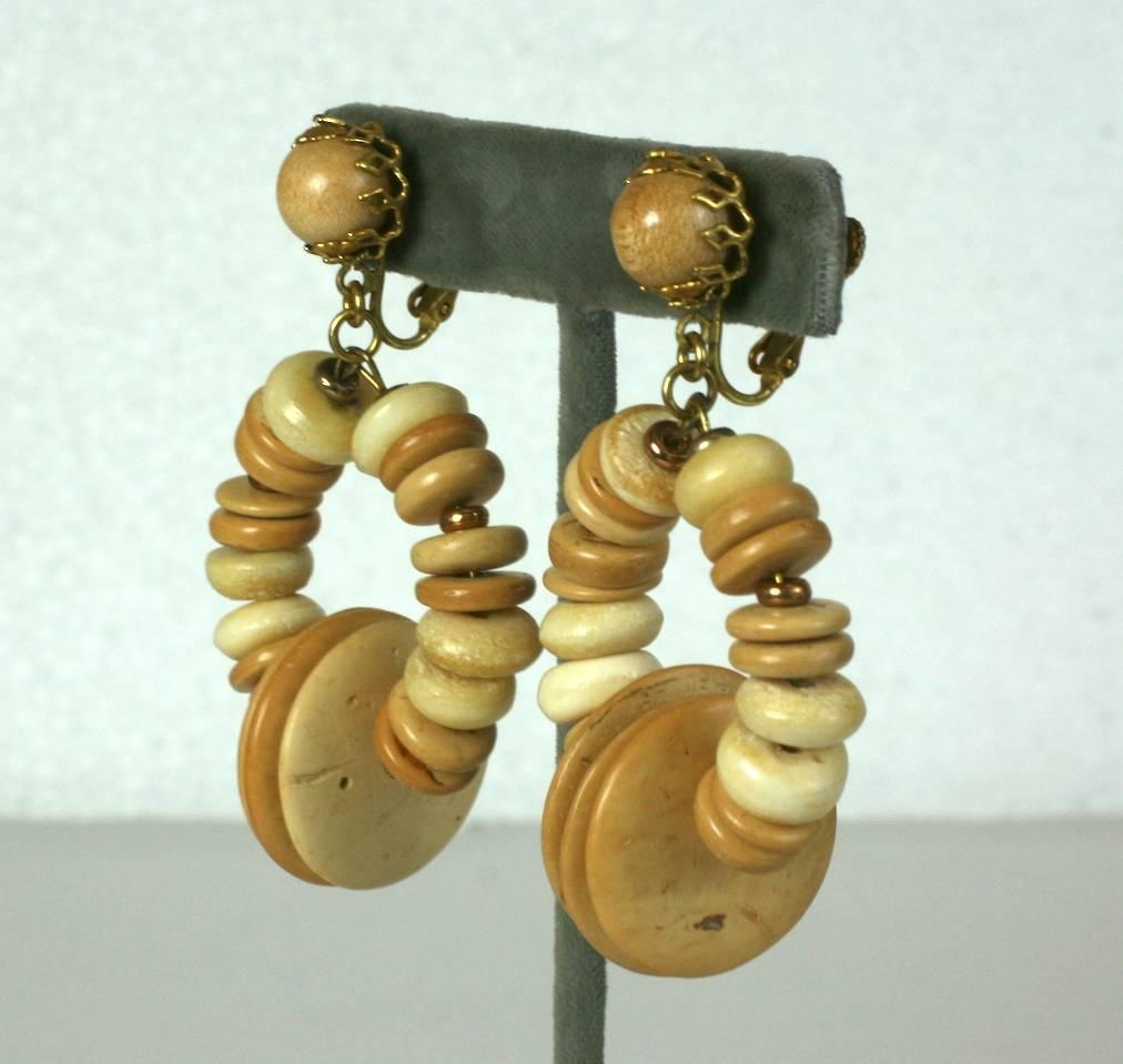 Miriam Haskell Beaded Hoop earrings of tonal wood beads in various shapes and sizes. Large striking scale and not heavy in weight. Clip back adjustable fittings. 1960's USA. 
Excellent condition.
2.5" x 1.5". 