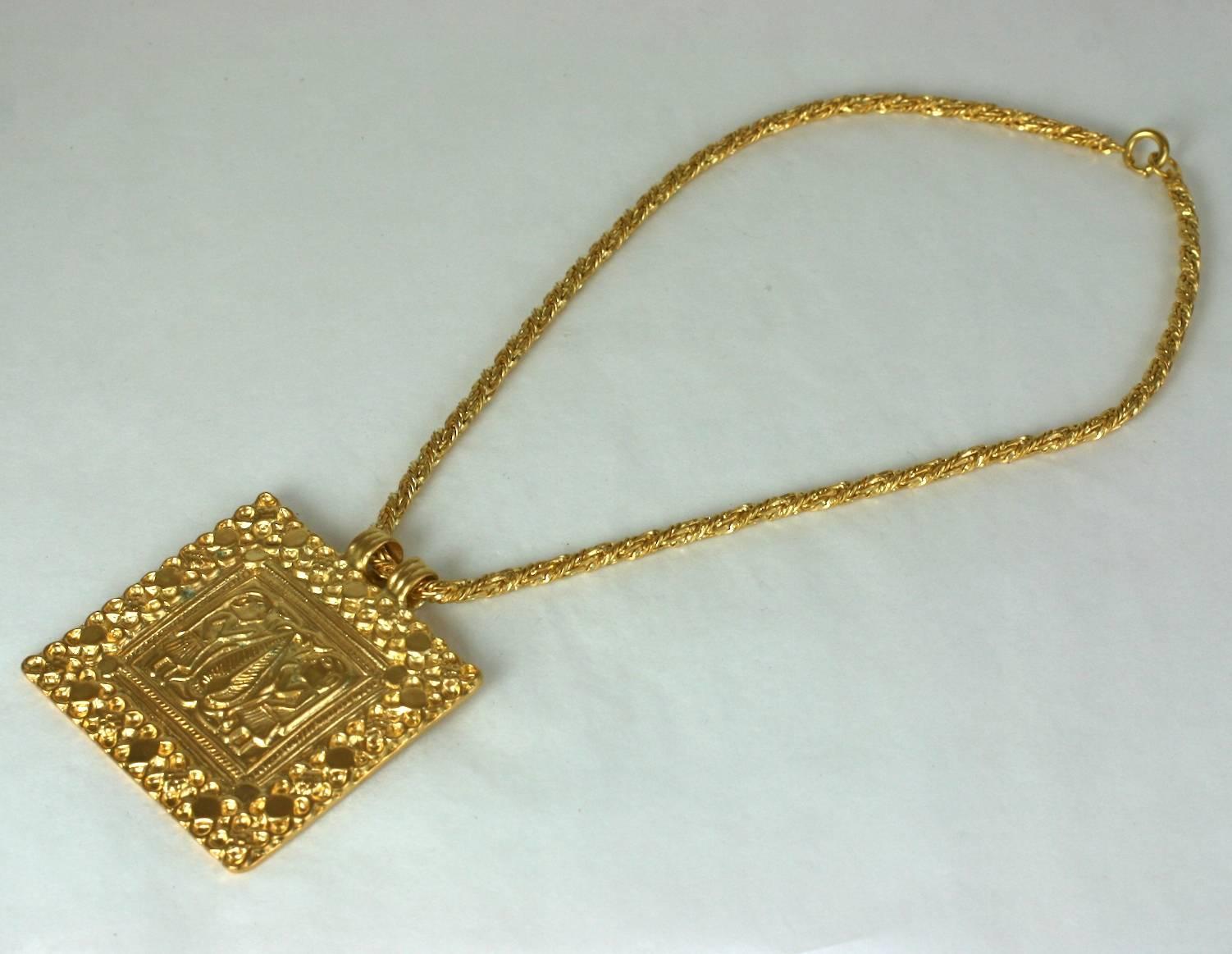  Line Vautrin The Tree Of Life pendant necklace in gilt metal, the model created around 1937 this one realized around 1950. With center motif of a stylized tree flanked by two figures representing Adam and Eve. This pendant is unsigned. 
LINE
