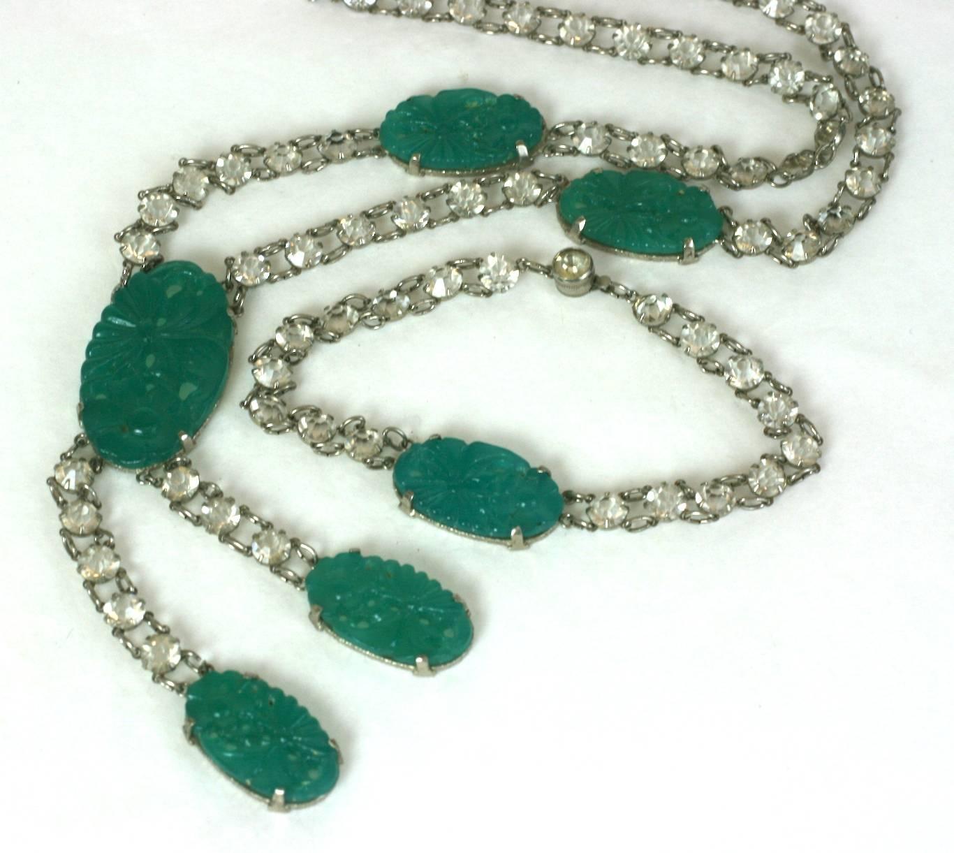 Delicate Art Deco Faux Jade Paste Suite from the 1920's. Stations of faux jade molded pate de verre are attached to prong set crystals. Pendant has double asymetrical drop. Bracelet has one central faux jade station. 
Delicate yet extremely