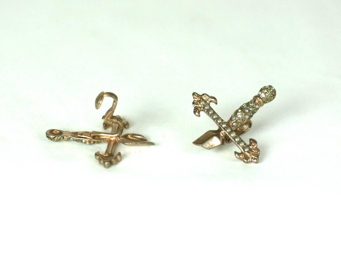 Amusing Gilt Silver Sword Hilt Earrings by Nettie Rosenstein. Set in pink gold plated sterling set with faux seed pearls and paste decoration. 
Often Nettie Rosenstein jewelry was sold in sets and the larger pieces were signed. This is likely the