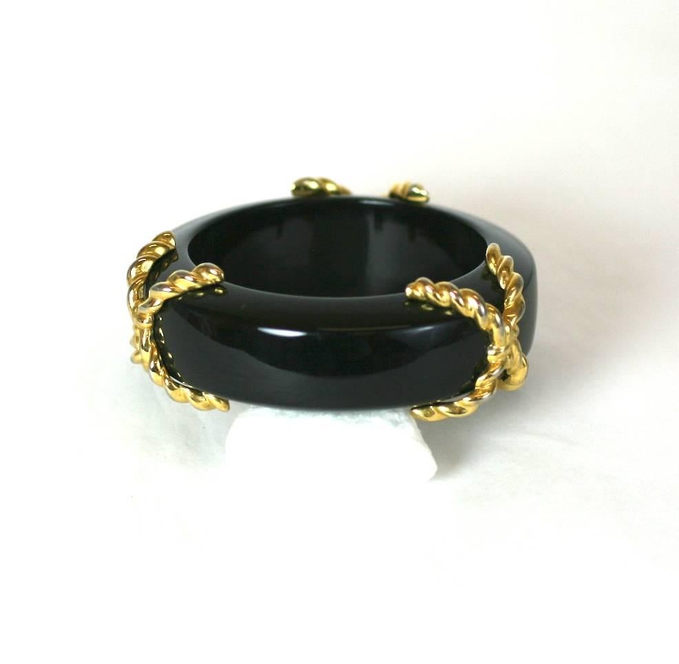 Chunky Black Bakelite bangle, decorated with three twisted gilt 