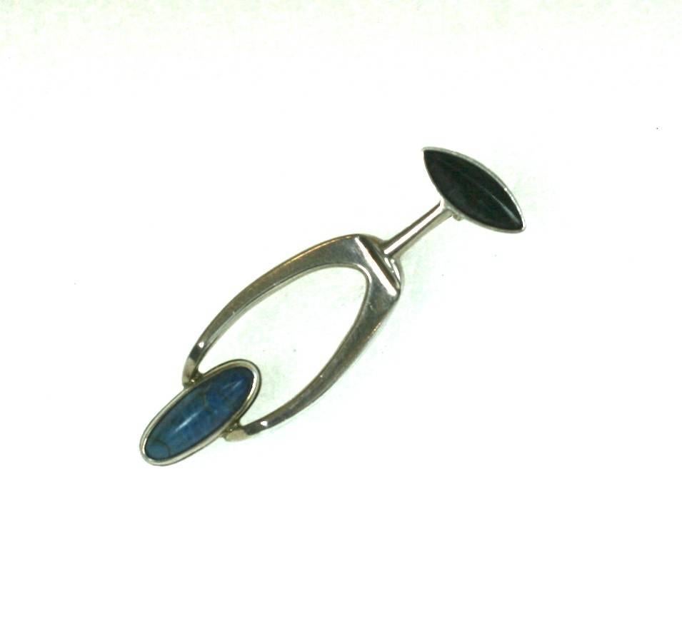 Osaki Sterling Modernist Brooch from the 1950's USA. High style modernist brooch is hand made       with an oval bezel set sodalite and patinaed silver forms. 
Excellent condition. 
2" x .6". 