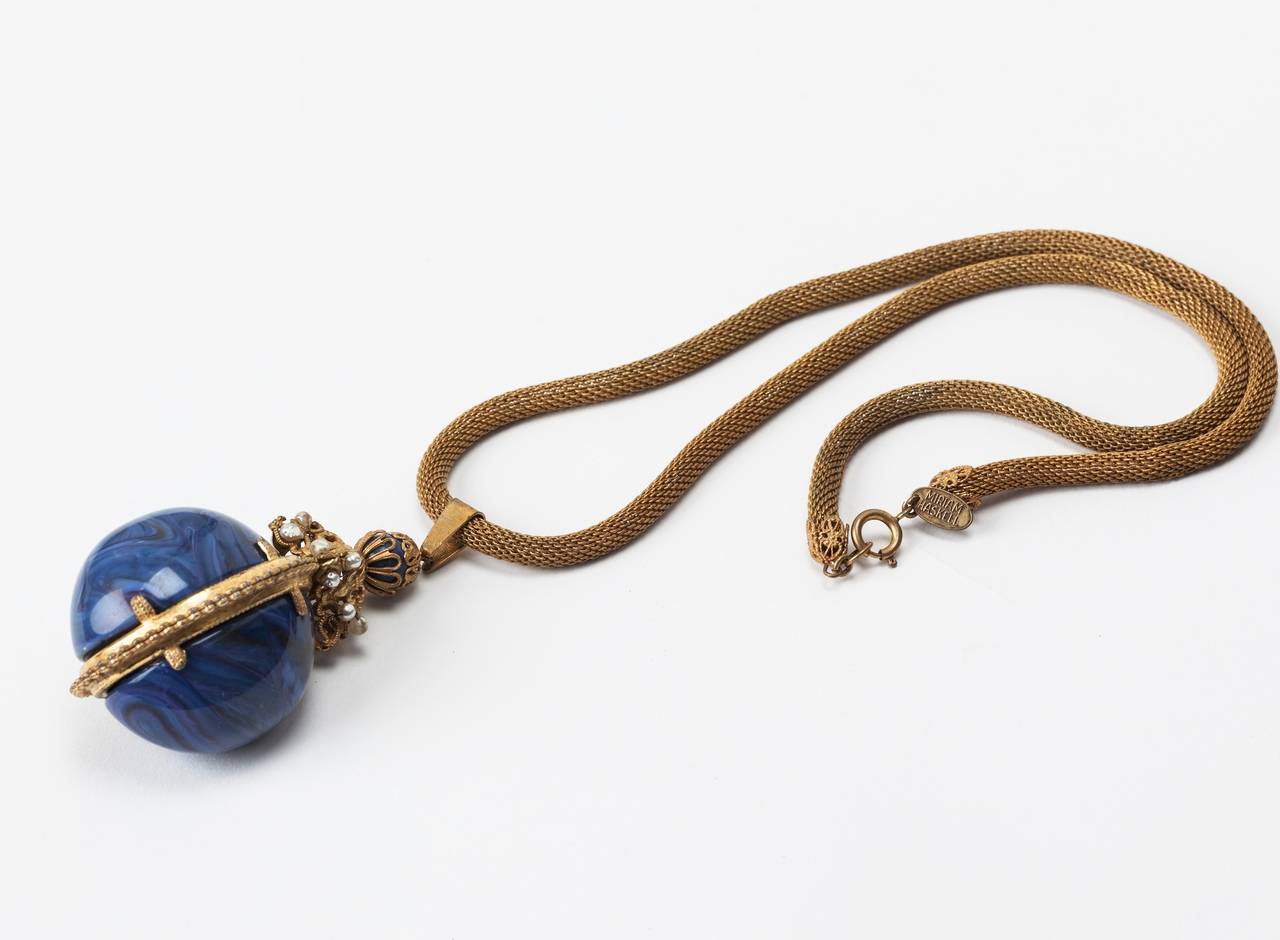 Miriam Haskell naturalistic lapis bakelite Russian Imperial egg inspired necklace. Signature Haskell russian gilt, faux pearls and fine woven gilt snake chain.
L2.75" pendant, W 1.75 pendant center. Chain L 25.75". 1960's USA.
Excellent