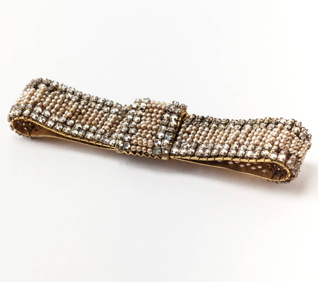 Miriam Haskell signature intricate seed pearl pave and crystal rose montees long bow tie brooch. Exquisite quality. 1950's USA. 
L 3.50", W.75"
Excellent condition.