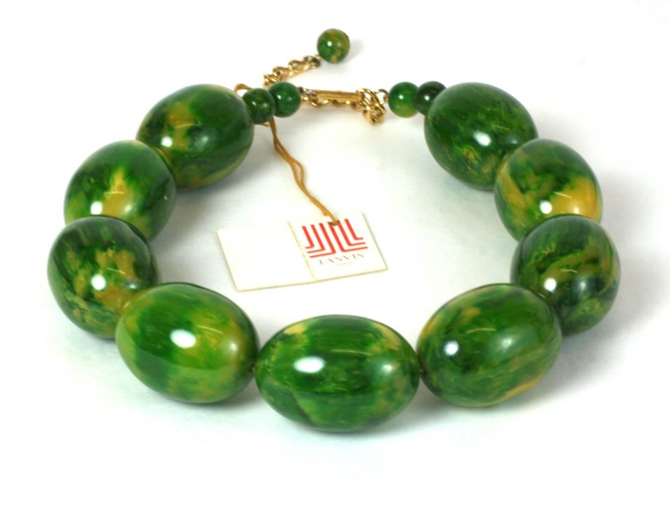 Lanvin End of Day Green Bakelite Beads from the 1970's. Oversized mottled green bakelite egg shaped beads are used for this imposing necklace. 
Retains original paper label. 1970's France.
Excellent condition. 
Adjusts from 16" to 19",