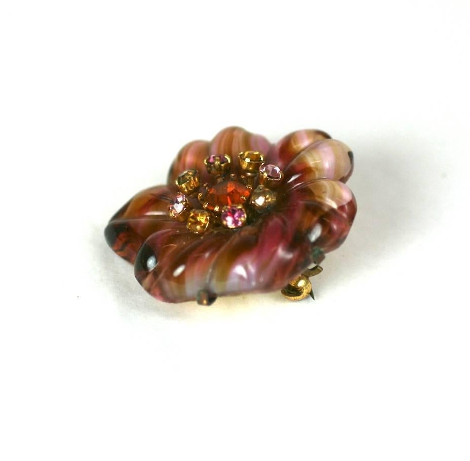 Unusual Czechoslovakian Art Glass Flower Brooch with multicolored paste center. Unusual slag glass style molded flower in tones of caramel and rasberry are set  against coordinating pastes in pink and citrine.  Brass setting on pin back. Wonderful