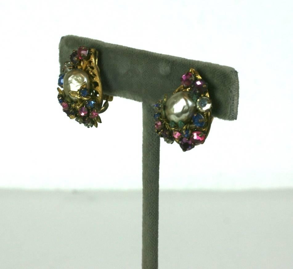Miriam Haskell Pearl and Multicolored Paste Leaf Earrings circa 1940's. A large central faux pearl is surrounded by hand sewn colored rose montees in signature Russian gold finish. Clip back fittings. 1940's USA. 
Excellent condition. .75" x