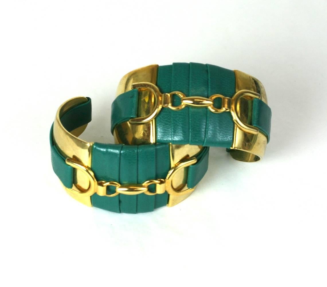 Pair of gilt metal and faux green wrapped leather cuffs mounted with gilt horse bit motifs. USA 1960's. 
Excellent Condition
Width 1 7/16