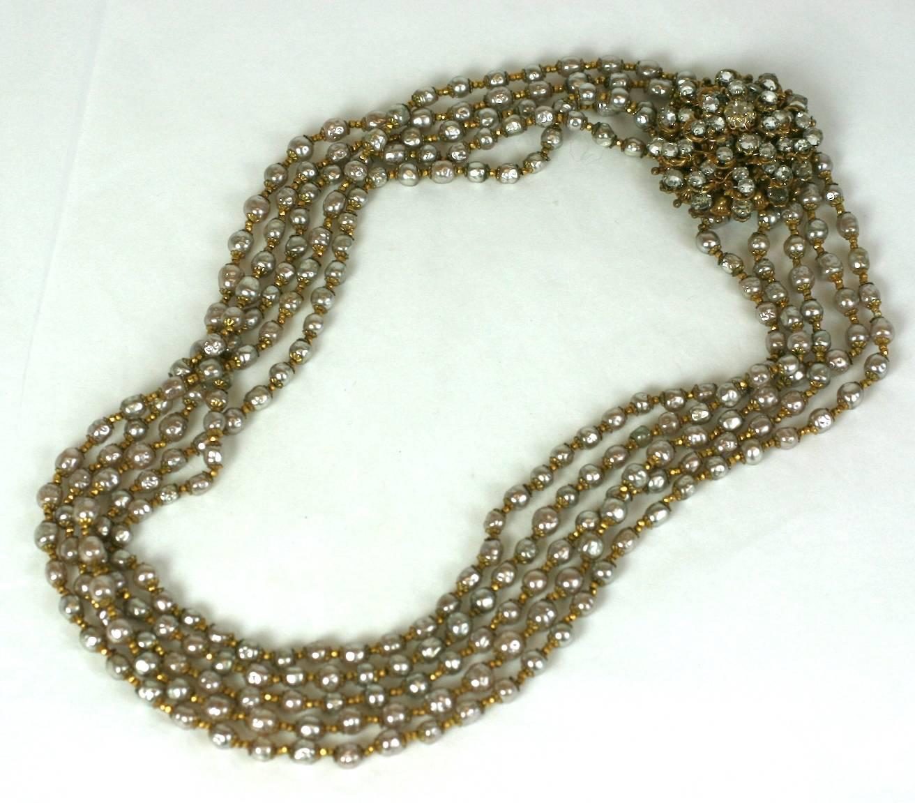 Miriam Haskell signature baroque faux pearl graduated five strand necklace.The  large elaborate clasp composed of layered floral Russian gilt filigrees, crystal pastes and rose montes. The baroque faux pearls are spaced with gilt faceted
