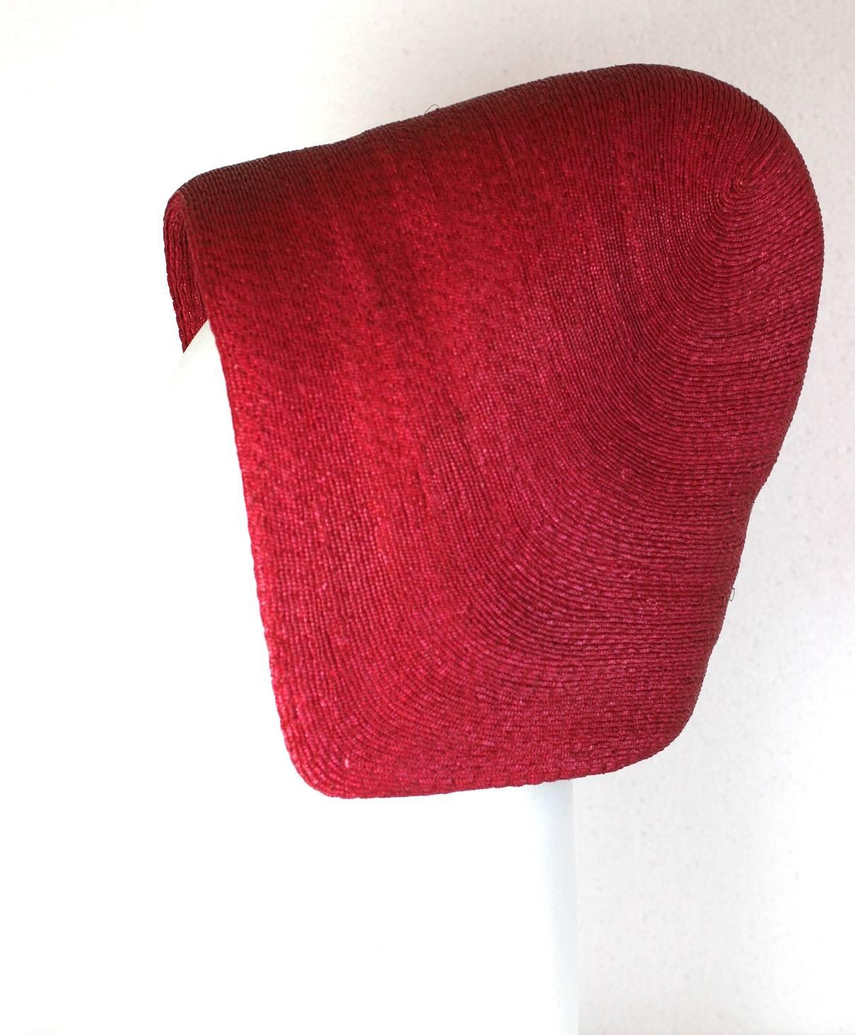 Adolfo French Straw Early Bonnet in bright cherry red. Unusual design evocative of Parisian 1960's Space Age Shapes. 
Excellent condition. 
Although Adolfo established his reputation in America as a designer for the ladies who lunched, he acquired