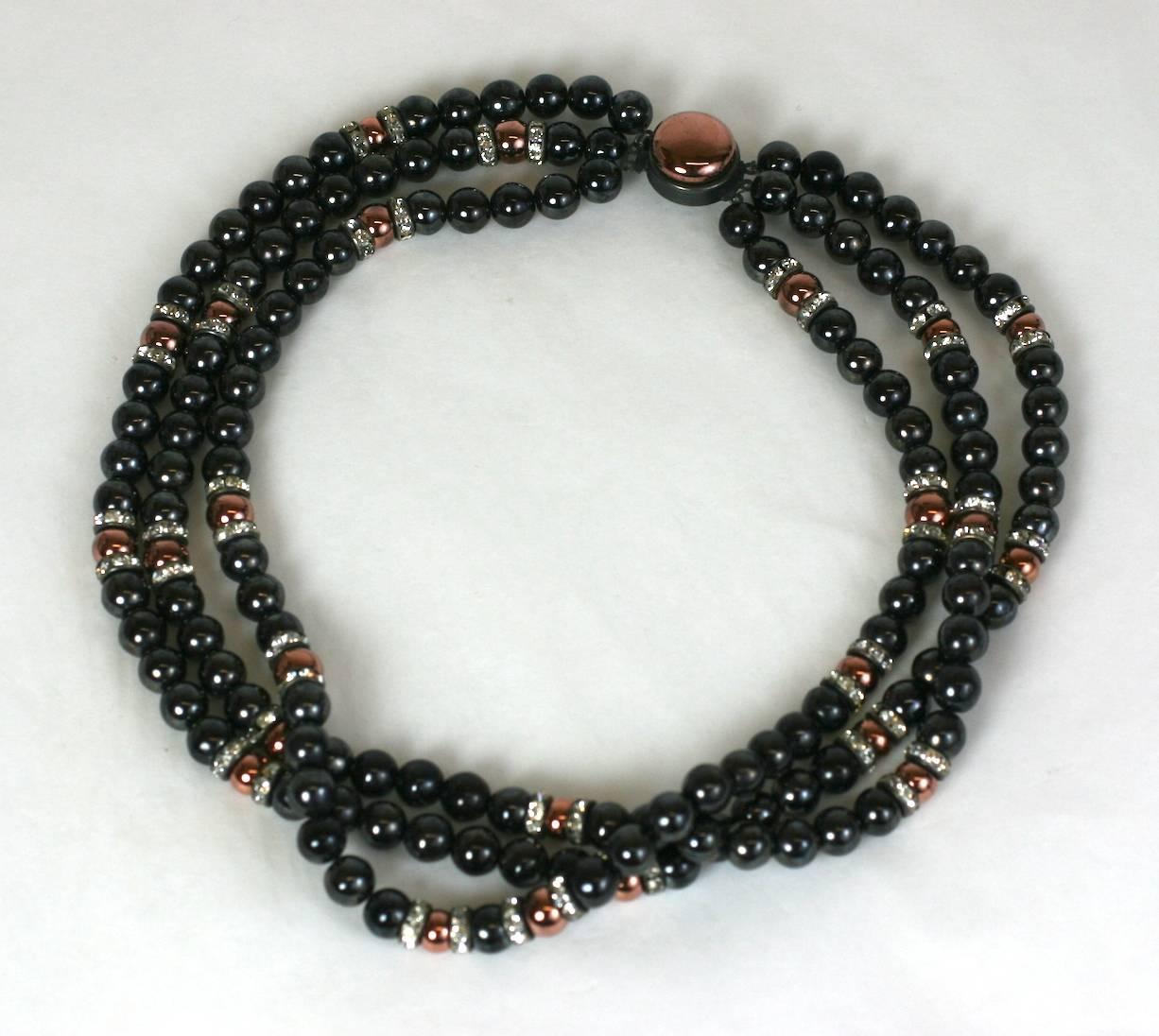 Louis Rousselet three strand faux hematite and copper glass necklace with crystal rondelle accent spacers and cabocheon copper glass clasp. Unusually modern juxtapositions of colors. Made in France. 1930's. 
Excellent Condition
Length 16"
Width