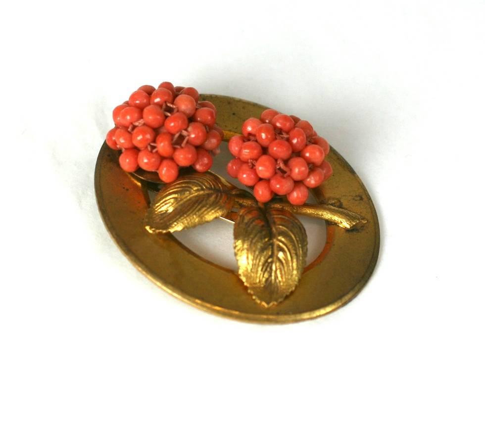 French Art Deco natural coral flower bud clip brooch.The coral beads hand sewn in the form of flower heads,and set on gilt  stems and realistic leaves. Clip back fitting for wear on garment edges (neckline, lapel etc). Excellent Condition. 
Domestic