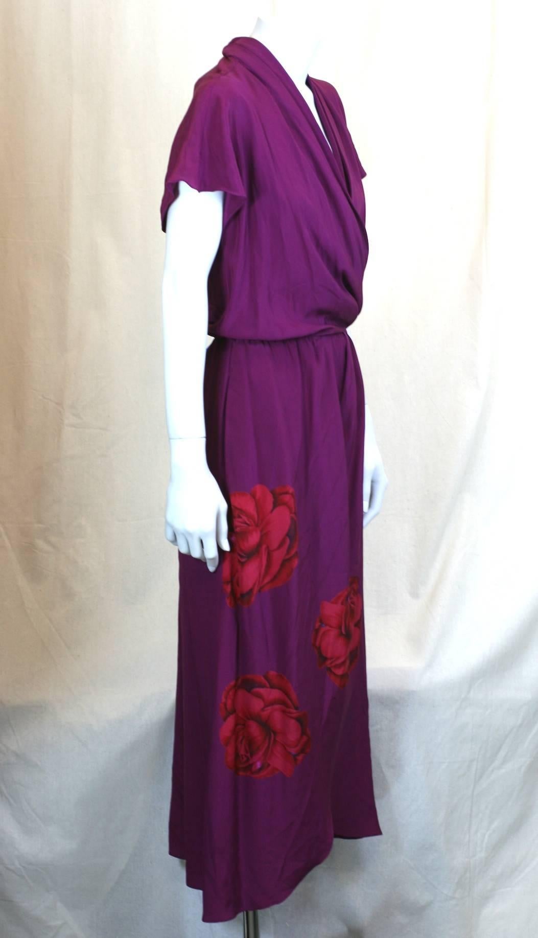 Perry Ellis photo print, placed rose one piece wrap dress. Purple silk crepe de chine with graphic red and black printed blooms. Draped bias cut top with elastic waist which snaps in place across front. Dipping hem, no belt. 1990s USA. 
Excellent