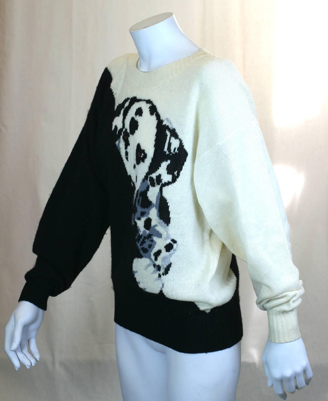 Krizia inquisitive peeking dalmation puppy intarsia knit pullover, the black and white puppy peeking over the black diagonal sweater front. Ribbed knit cuffs and hem. Modified dolman sleeves. 1980's Italy. Made in Italy, Iconic Krizia Motif. 
Wool