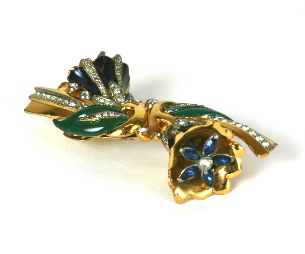 Coro by Adolph Katz, quivering bell flower trembler duette brooch with cold enamel accents. The double clips embellished with crystal pave and faux sapphire trembling stamen in each bell flower. 
Flower clips separate off base and can be worn