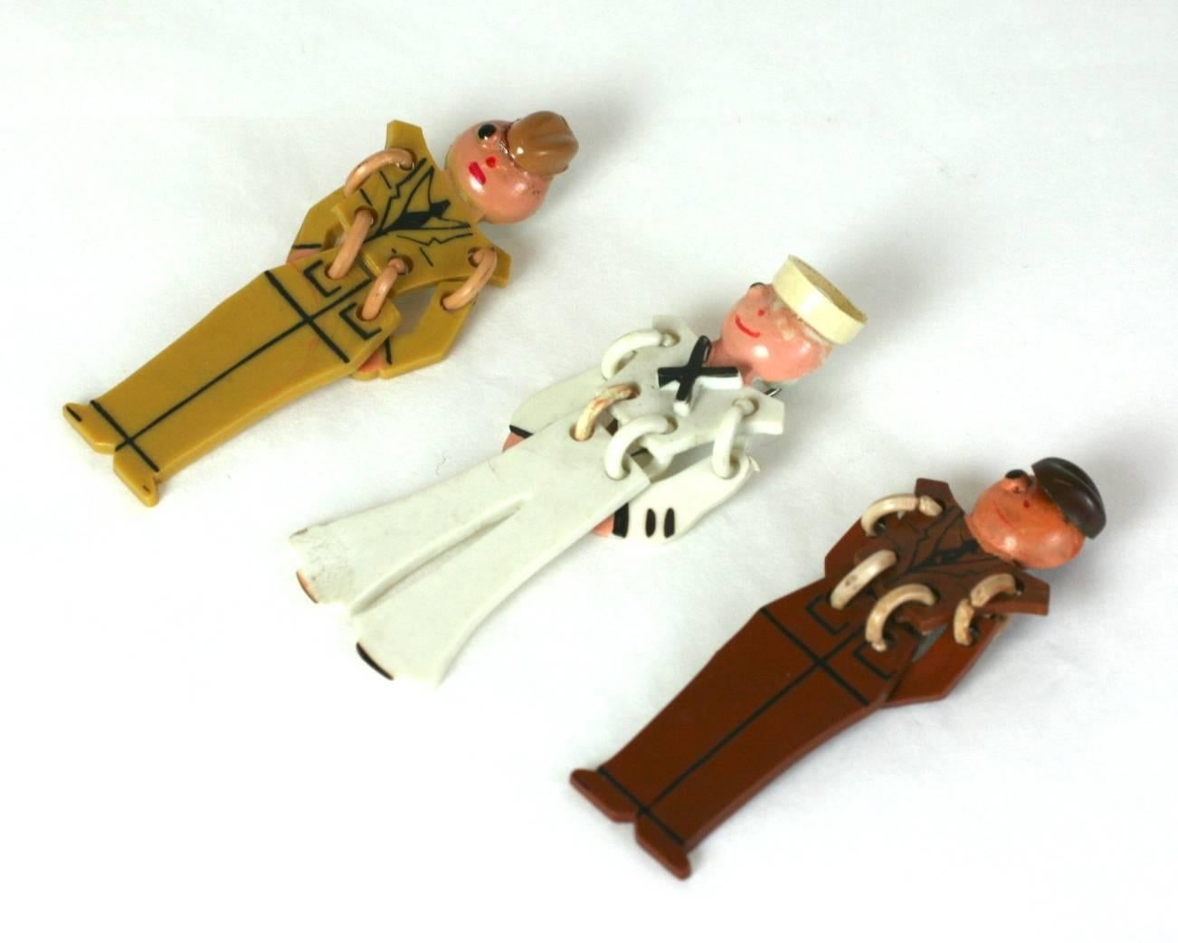 Art Deco Celluloid Soldier Boy brooches from the 1930's. Each represents a different character with moveable arms and legs. A charming reminder of the early 20th Century. 
Each measures 2.75