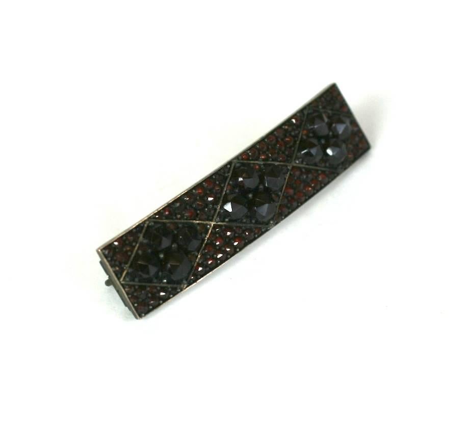 Victorian Garnet Pave Bar Pin from the late 19th Century. Large rose cut cabochon garnets are set in a micro pave field of tiny garnets which make for a very lush effect. There is almost no metal, just pave garnets which are all a rich, deep wine