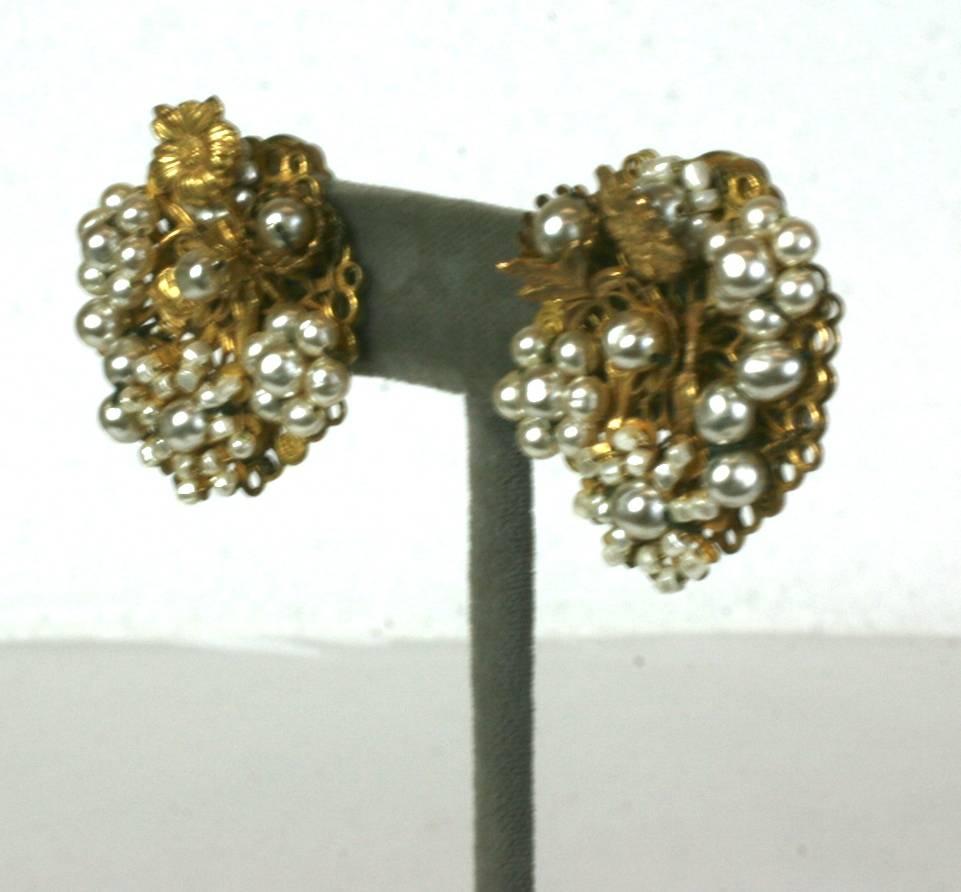 Miriam Haskell Embroidered Faux Pearl ear clips from the 1950's. Faux pearls are hand sewn onto the signature Russian Filigree bases with gilded flower accents. Clip back fittings.  1.25