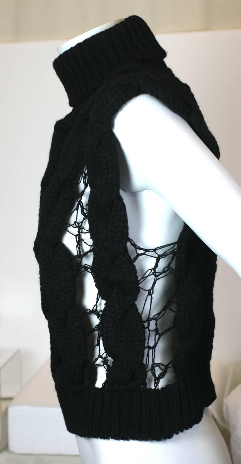 Veronique Branquinho Open Work Hand Knit Cabled Vest in inky black wool. Deep turtleneck collar with a series of heavy cabled braids hand knit with delicate openwork bridges in between. 
Cool and amazing contrast of textures from this acclaimed