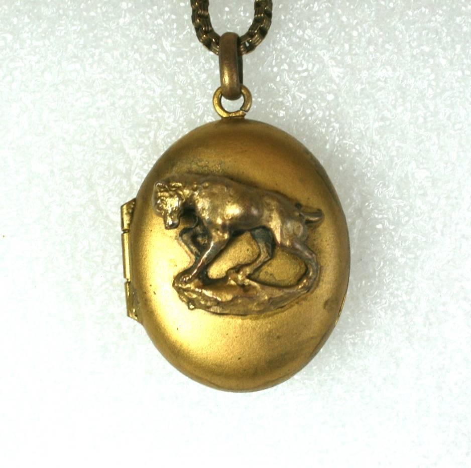 Victorian Gold Filled Dog Locket from the late 19th Century. Locket has a matte gold finish with a motif of a dog perched upon rocks. Unusual subject matter. 
1870's USA. Chain is period correct but not original. 
Locket 2