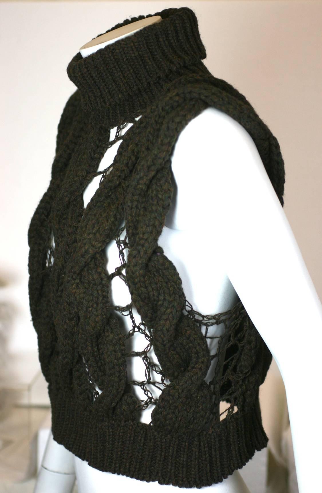 Veronique Branquinho Open Work Hand Knit Cabled Vest in tweedy brown wool. Deep turtleneck collar with a series of heavy cabled braids hand knit with delicate openwork bridges in between. 
Cool and amazing contrast of textures from this acclaimed
