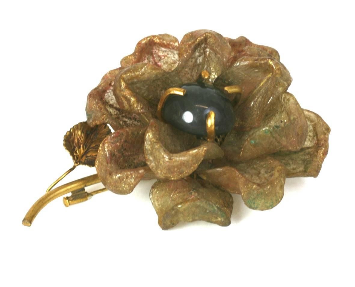 Felix, France rare resin and gilt metal flower brooch. Composed of hand made resin petals stained and cold patinaed a reddish gold and dusted with gold mica. Metal stem with ochre tinted leaf and focal prong set agate? cabochon, form the body of