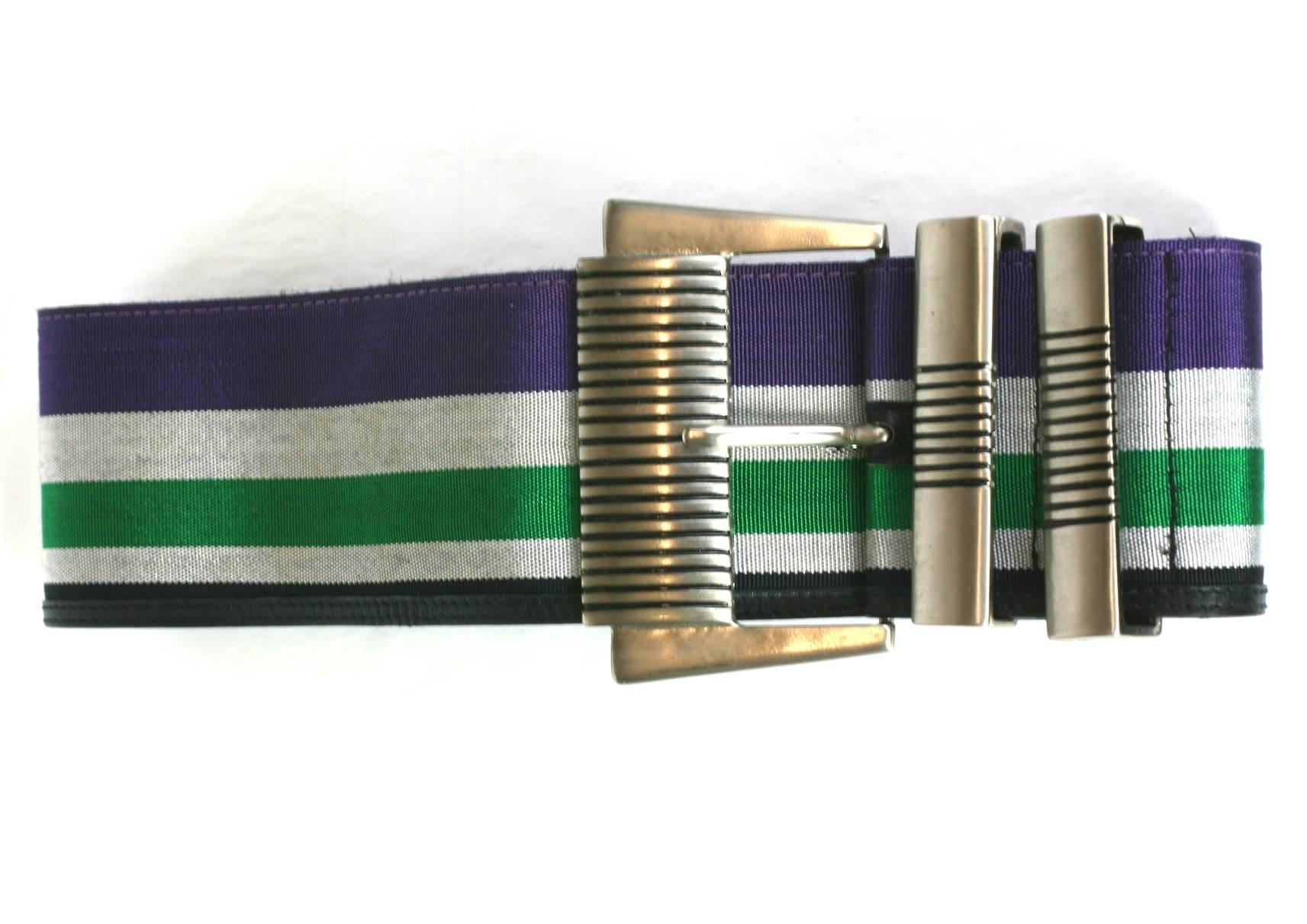 Gianni Versace woven striped belt. Large antiqued silver ribbed buckle with woven striped ribbon in shades of pale gray, green, purple with a band of fine black leather on one edge.
Stamped Gianni Versace, Excellent Condition.
Size Italian 70/ 28, 