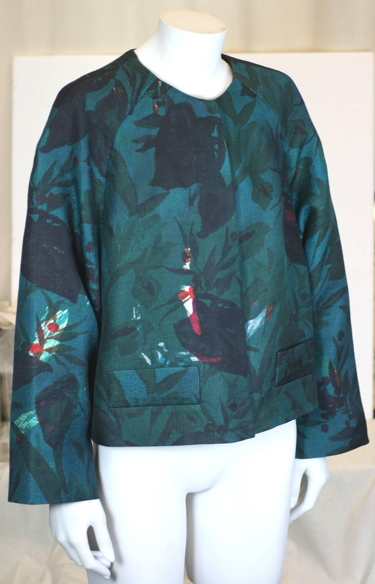 Dries Van Noten Dark Floral Jacket in wool/silk blend. Strikingly elegant print in deep tonal colors. 
Jacket is cut full with large snap closures. Tucks at the back of neck balloon out the back of the jacket. 2000's France. 
Size 42. Excellent