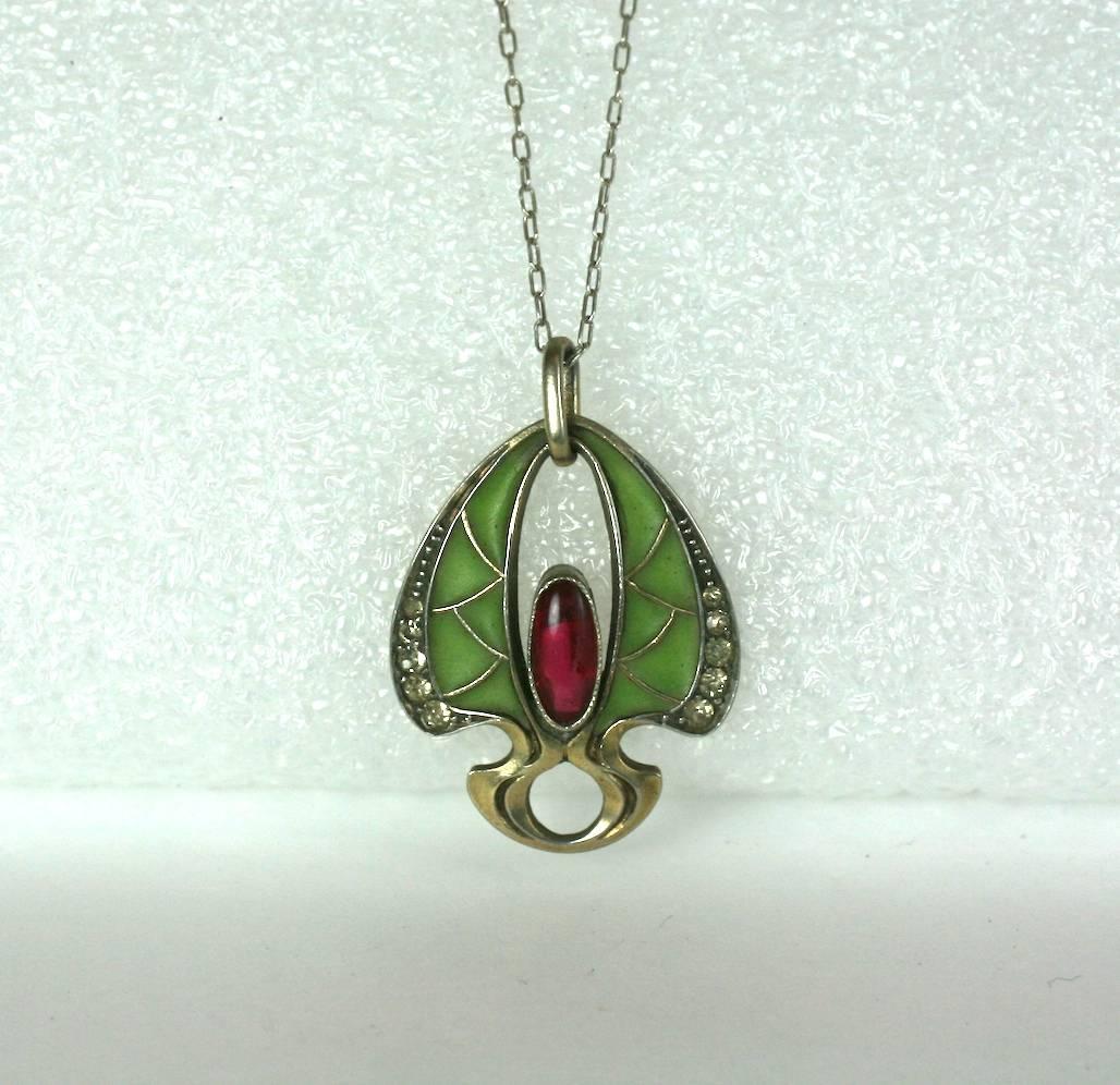 Art Nouveau Plique a Jour translucent jade green enamel and sterling silver pendant necklace. Centered with focal oval cabochon ruby paste and edged with crystal pave.
Stamped 900, silver standard. France 1890's. 
Excellent Condition. 
L 1