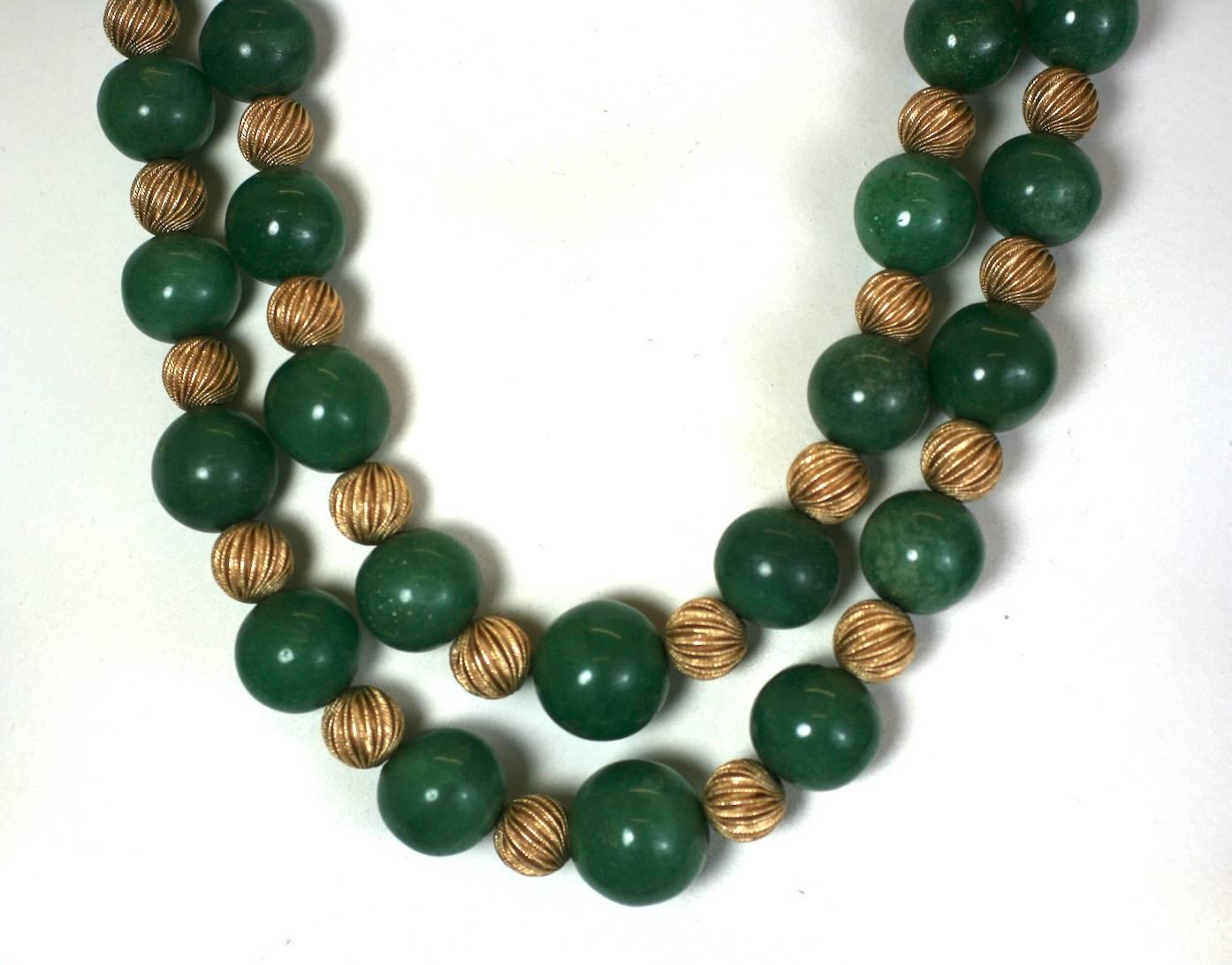Striking and substantial Adventurine bead and Ribbed Gold Bead Necklace. Double strand with fluted, ribbed gold 14k beads alternating with deep green, slightly sparkly adventurine beads. Large flat cabochon clasp with 14k gold twist detailing. 
23