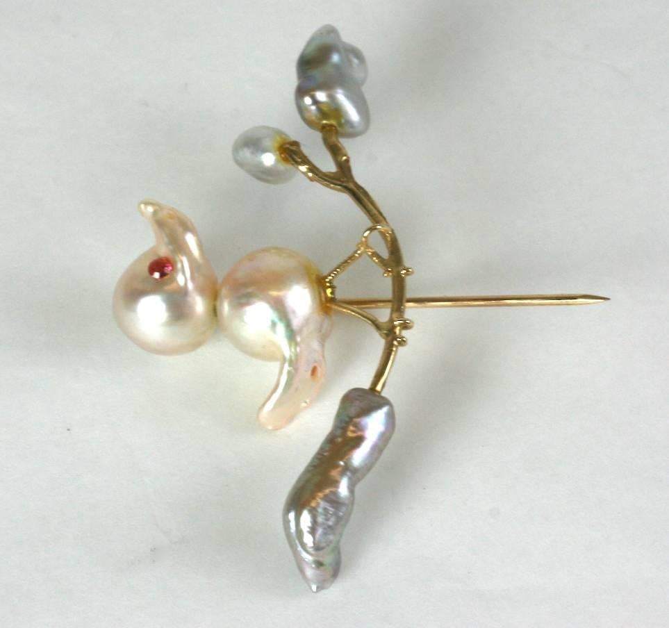 Charming Biwa Pearl Birdie on branch stickpin brooch, made from irregular biwa pearls with ruby eyes, all set in 14k gold.
1950's USA.
Excellent condition. 
2.25" x 1.25" high