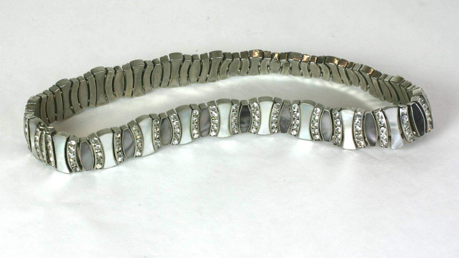 Lovely mid Century Mother of Pearl and Pave Choker of dark and white mother of pearl ovoid panels separated by channel set pave rhinestones. Lovely quality and construction. 
West Germany, 1950's.
14.75" x .75". 