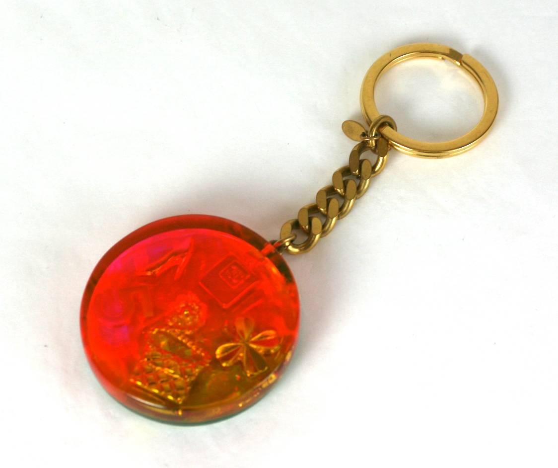Authentic  rare Chanel Hologram  fob key chain or bag charm. A signature gilt curb chain suspends a  round fob embedded with gilt motifs which display Chanel's codes with in a lucite multi color hologram. Signed, spring 1997. 
Excellent Condition.