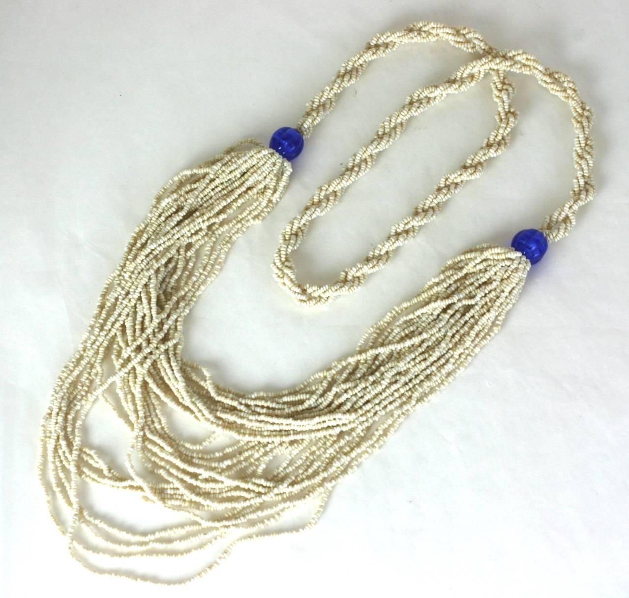 Lovely Art Deco Maison Gripoix rope necklace of micro faux seed pearls. The upper strands of the necklace are softly twisted and braided while lower bib falls in loose draped strands, with faux sapphire melon cut bead stations. 1920's France.