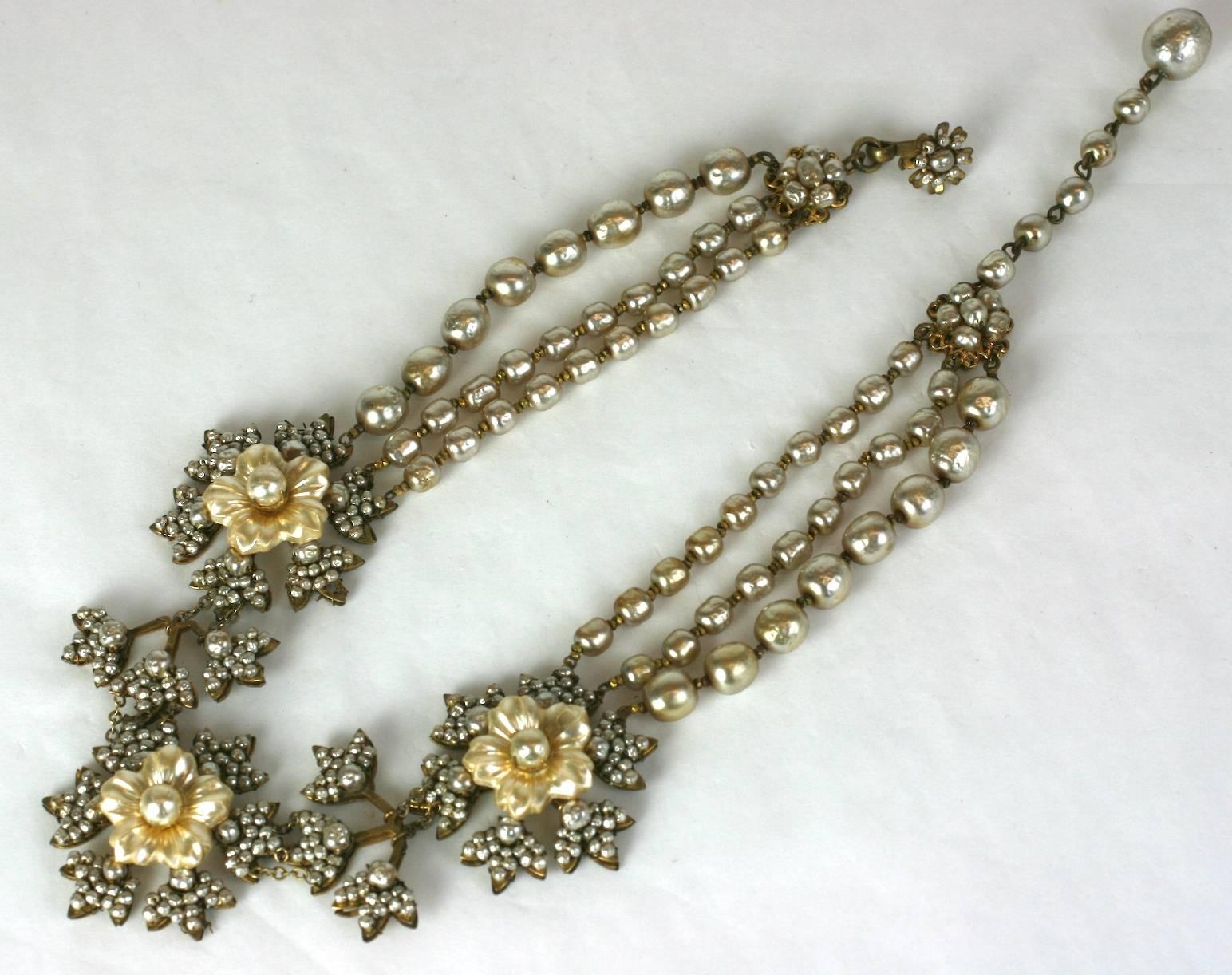Elegant Miriam Haskell three strand signature faux baroque pearl elaborately detailed necklace. Of pearl carved glass flower heads and seed bead faux pearl embroidered filigree leaves. 
Excellent Condition. 
Length 14.50
