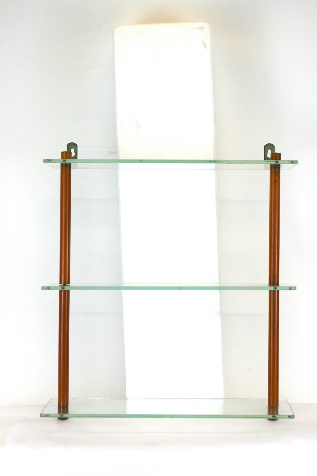 Art Deco Bakelite Shelf, perfect for your display of bakelite barware and objects! 
Glass shelves with caramel Bakelite clad metal rod supports.  1930's USA. 
14" wide x 5" deep, 16" high. 
Excellent condition. 